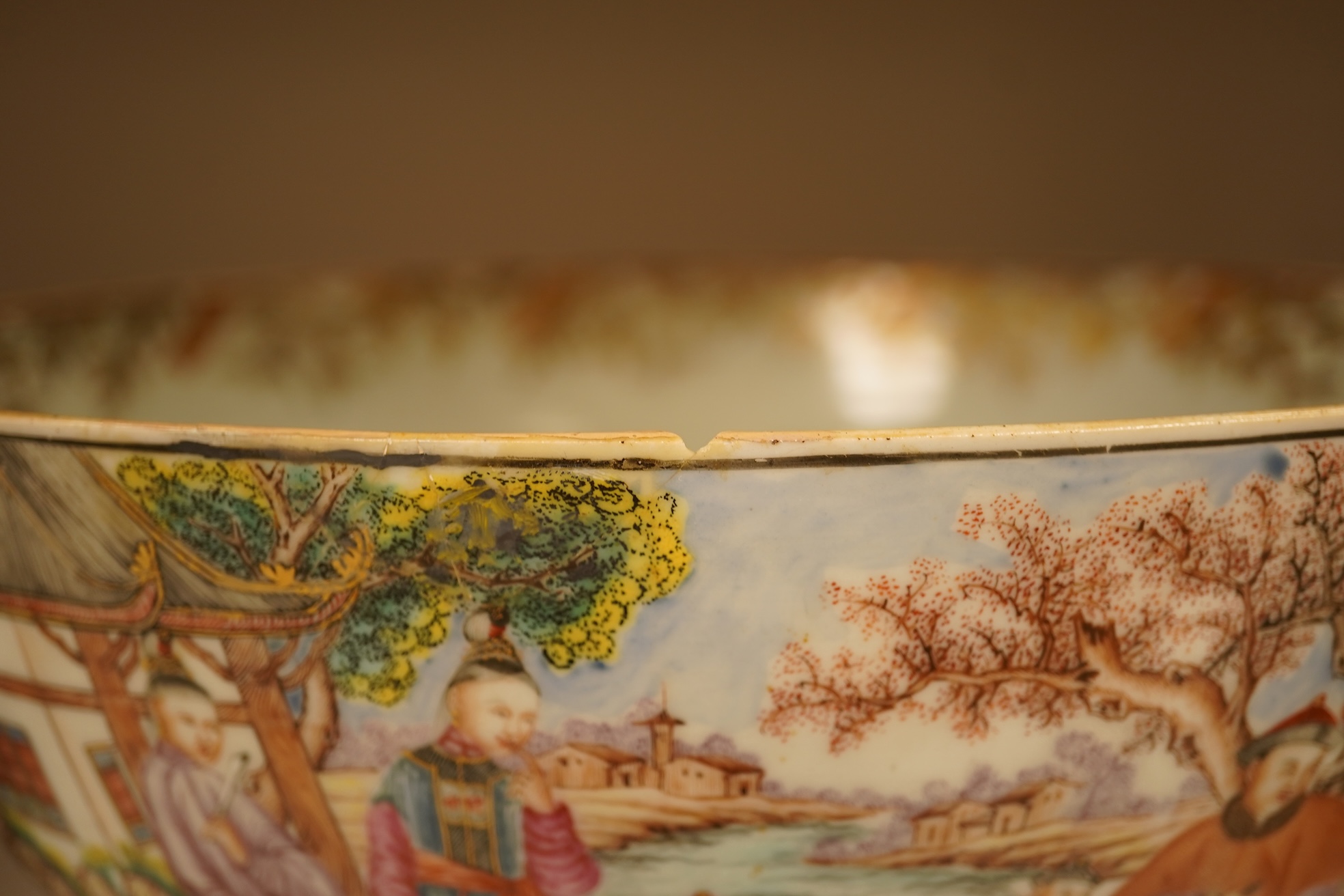 An 18th century Chinese famille rose figural bowl, on wooden stand, 34cm diameter.